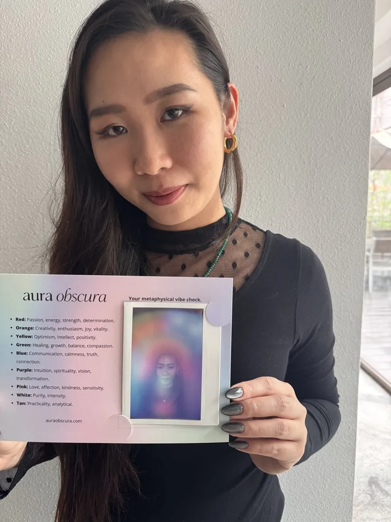 guest holding her aura keepsake card