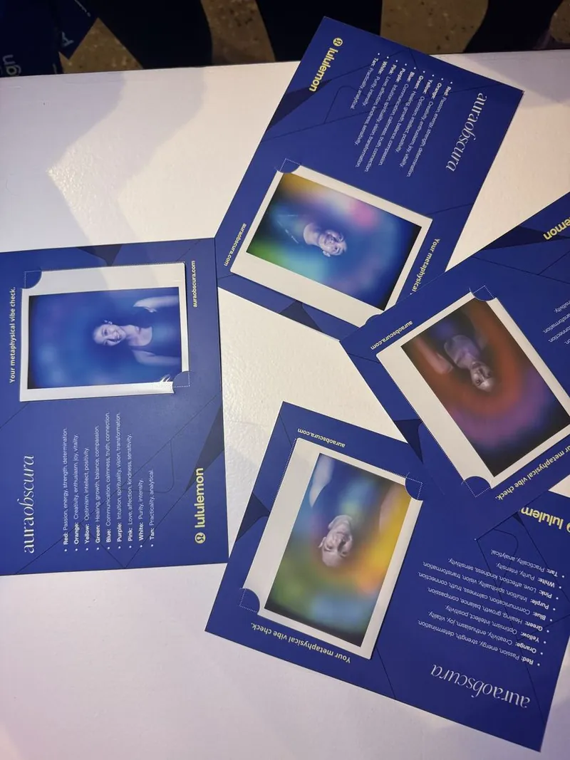 co-branded lululemon × aura obscura keepsake cards laid out at the pop-up